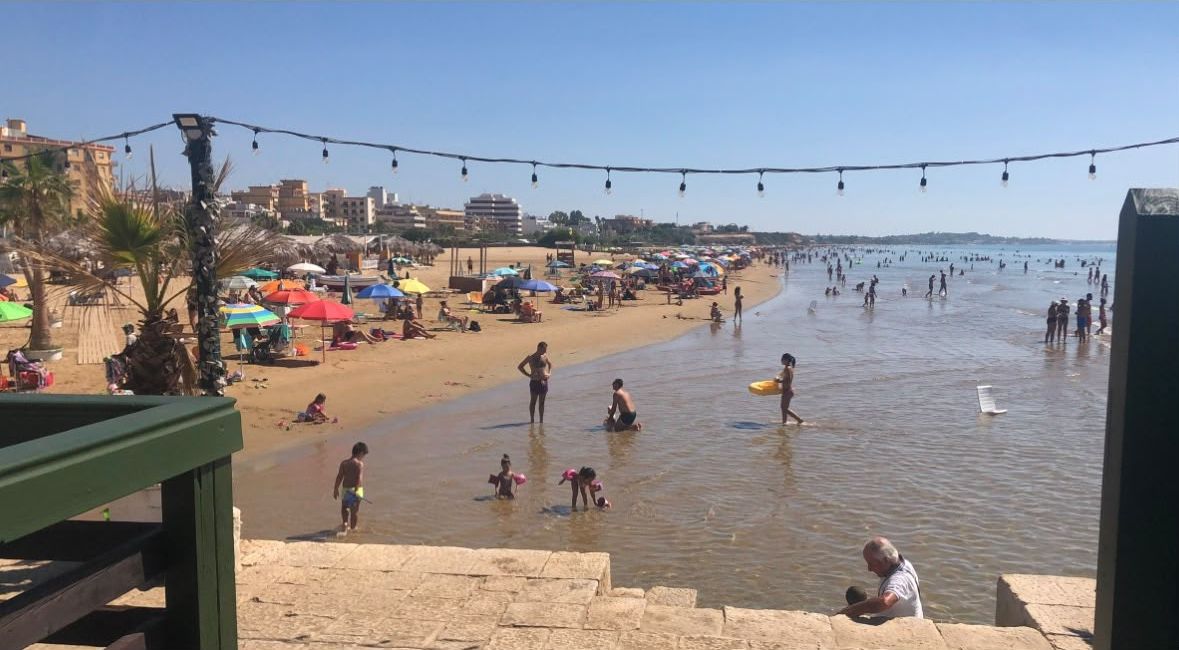 Children playing in the shallow water at Pozzallo beach